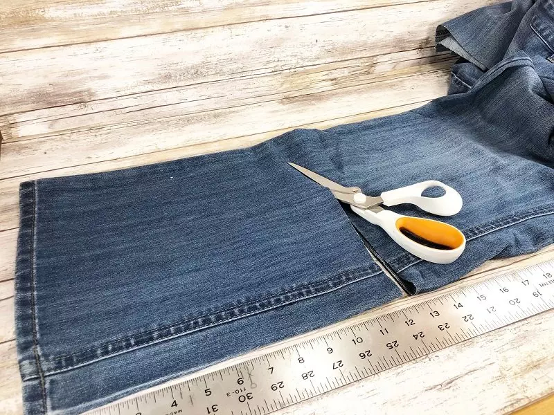 Measure and cut the jean legs to 12 inches and 14 inches Creatively Beth #creativelybeth #upcycle #recycle #denim #crafts #falldecor #pumpkins #autumndecor #diy