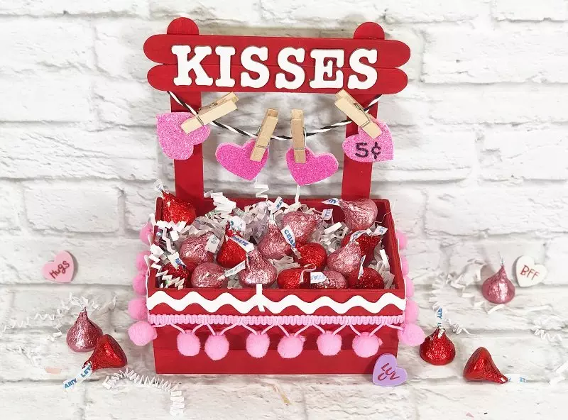 Valentine Kisses Booth Dollar Tree Crafts Creatively Beth #creativelybeth #dollartree #crafts #diy #kissesbooth #kissingbooth #craftstick #popsiclestick #valentine #valentinesday #hersheykisses #kidscraft