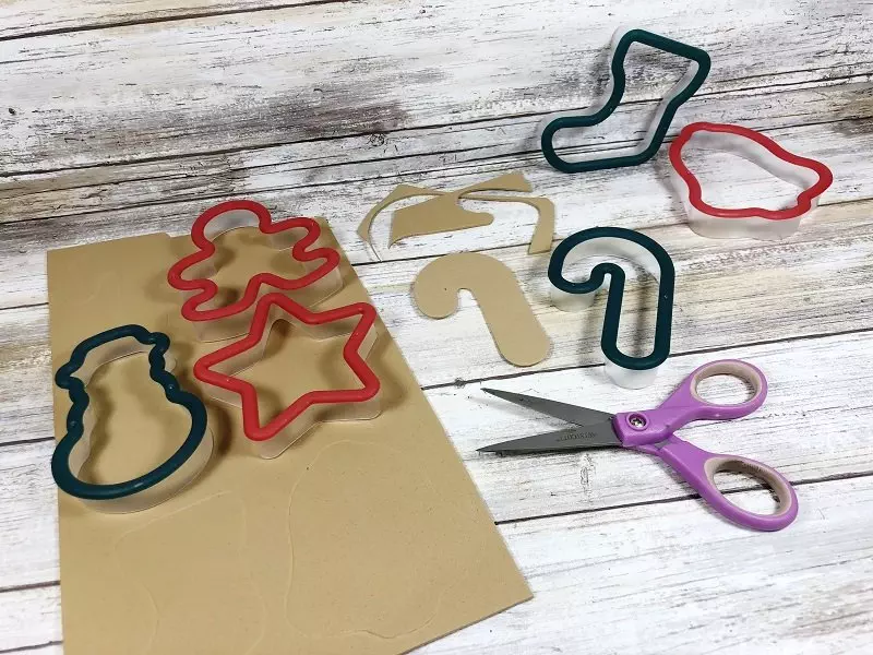 Cut out craft foam cookies with scissors #creativelybeth #dollartreecrafts #christmascookies #kidscrafts